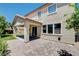 Back exterior featuring a paver patio with a covered area and a well-maintained lawn at 6569 Cedar Waxwing St, North Las Vegas, NV 89084