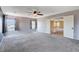 Spacious bedroom featuring plush carpet, ceiling fan, and view of the surrounding landscape at 6569 Cedar Waxwing St, North Las Vegas, NV 89084