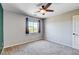 Neutral bedroom featuring a ceiling fan, plush carpet, a window, and a closet door at 6569 Cedar Waxwing St, North Las Vegas, NV 89084