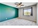 Bedroom with an accent wall, neutral paint, a ceiling fan and plush carpet at 6569 Cedar Waxwing St, North Las Vegas, NV 89084
