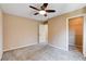 Bedroom featuring plush carpeting, a ceiling fan, and a walk-in closet with wire shelving at 6569 Cedar Waxwing St, North Las Vegas, NV 89084