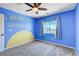 Blue bedroom with 'You are my sunshine' wall art, ceiling fan, and window at 6569 Cedar Waxwing St, North Las Vegas, NV 89084