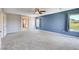 Large bedroom with soft carpeting, bright natural light, and a ceiling fan for added comfort at 6569 Cedar Waxwing St, North Las Vegas, NV 89084