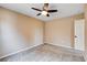 Bedroom with neutral paint, plush carpeting, a ceiling fan and a white door at 6569 Cedar Waxwing St, North Las Vegas, NV 89084