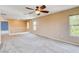 This open bonus room features plush carpeting, a ceiling fan, and lots of natural light at 6569 Cedar Waxwing St, North Las Vegas, NV 89084