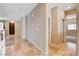 View of a wide hallway leading to various rooms and a wood front door at 6569 Cedar Waxwing St, North Las Vegas, NV 89084
