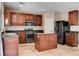 Modern kitchen features dark wood cabinets, stainless steel appliances, and a granite island at 6569 Cedar Waxwing St, North Las Vegas, NV 89084