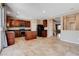 Spacious kitchen with granite countertops, stainless steel appliances, ample cabinet space, tile floor, and open access to other rooms at 6569 Cedar Waxwing St, North Las Vegas, NV 89084