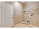 Utility room featuring tile flooring, storage shelving, and laundry hookups at 6569 Cedar Waxwing St, North Las Vegas, NV 89084