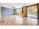 Open-concept living area with tile flooring, a ceiling fan, and sliding glass doors at 6569 Cedar Waxwing St, North Las Vegas, NV 89084