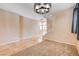 Bright living area with carpet and tile flooring, with modern light fixture and access to the upper level of the house at 6569 Cedar Waxwing St, North Las Vegas, NV 89084