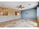 Spacious living room features tile floors, a ceiling fan, and plenty of natural light at 6569 Cedar Waxwing St, North Las Vegas, NV 89084