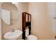Powder room featuring a round mirror and built-in cabinet over the toilet at 6569 Cedar Waxwing St, North Las Vegas, NV 89084