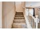 Carpeted stairs with white railing leading to the upper level of the home at 6569 Cedar Waxwing St, North Las Vegas, NV 89084