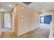 Carpeted upstairs hallway with access to bedrooms and other living spaces at 6569 Cedar Waxwing St, North Las Vegas, NV 89084