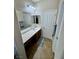 Well-lit bathroom featuring extended vanity with ample counter space and storage at 6614 Collingsworth St, Las Vegas, NV 89131