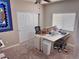 Bright room featuring a desk, neutral carpet, and white closet doors at 6614 Collingsworth St, Las Vegas, NV 89131