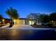 Charming single-story home featuring a two-car garage and neatly landscaped front yard at dusk at 6614 Collingsworth St, Las Vegas, NV 89131