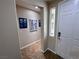 Inviting hallway with tile flooring and natural light from a nearby window at 6614 Collingsworth St, Las Vegas, NV 89131