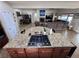 Open concept kitchen with bar, stove island, flowing to living room with fireplace and entertainment area at 6614 Collingsworth St, Las Vegas, NV 89131