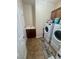 Efficient laundry room with modern washer and dryer and built-in sink for convenience at 6614 Collingsworth St, Las Vegas, NV 89131
