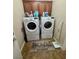 Functional laundry area with front-loading washer/dryer set and ample storage space above at 6614 Collingsworth St, Las Vegas, NV 89131