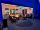 Covered patio area with outdoor seating, fire table, and ceiling fan at 6614 Collingsworth St, Las Vegas, NV 89131