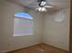 Cozy bedroom with neutral walls, a ceiling fan, and a window with a view of the outside at 700 Carnegie St # 4821, Henderson, NV 89052