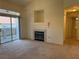 Living room featuring neutral carpet, fireplace, sliding door to balcony, and open floor plan at 700 Carnegie St # 4821, Henderson, NV 89052
