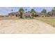 Expansive backyard with lush grass, mature palm trees, and a covered patio seating area on a desert property at 825 W Ryan Ave, Overton, NV 89040