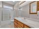 Bright bathroom featuring a shower-tub combo, toilet, and sink with wood cabinets at 825 W Ryan Ave, Overton, NV 89040