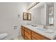 Well-lit bathroom boasts double sinks, tile flooring, and a wood vanity at 825 W Ryan Ave, Overton, NV 89040