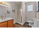 Functional bathroom with a vanity, toilet, and glass-enclosed shower, enhanced by a neutral color scheme and natural light at 825 W Ryan Ave, Overton, NV 89040