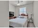 Bedroom features a ceiling fan and a large television at 825 W Ryan Ave, Overton, NV 89040