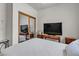 Bedroom with a mirrored closet and a desk area with a large screen television at 825 W Ryan Ave, Overton, NV 89040