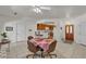 Open-concept dining area with tile flooring, a ceiling fan, and a view into the adjacent kitchen at 825 W Ryan Ave, Overton, NV 89040