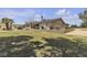 Expansive backyard with lush lawn and retaining wall showcasing the home's exterior at 825 W Ryan Ave, Overton, NV 89040