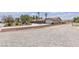 Expansive property showcasing desert landscaping, palm trees, and a long driveway to the charming single-story home at 825 W Ryan Ave, Overton, NV 89040