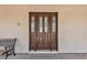 Inviting front door with decorative glass and sidelights, complemented by a welcoming 'Home Sweet Home' doormat at 825 W Ryan Ave, Overton, NV 89040