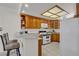 A well-lit kitchen area with breakfast bar, wooden cabinets, and modern appliances at 825 W Ryan Ave, Overton, NV 89040