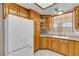 Inviting kitchen features wood cabinets, a white refrigerator, and a tiled floor at 825 W Ryan Ave, Overton, NV 89040