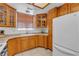 Well-maintained kitchen showcasing wooden cabinets, tile floors, and modern appliances at 825 W Ryan Ave, Overton, NV 89040