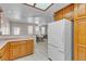 Bright kitchen featuring wooden cabinets and a white refrigerator with an eat-in nook at 825 W Ryan Ave, Overton, NV 89040