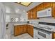 A kitchen with a microwave, gas range, wooden cabinets, tile floor, and lots of light at 825 W Ryan Ave, Overton, NV 89040