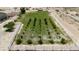 Aerial shot of a large, fenced parcel of land with planted saplings and irrigated grass, offering space and potential at 825 W Ryan Ave, Overton, NV 89040
