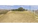 A vast open field is enclosed by a white fence and lush trees at 825 W Ryan Ave, Overton, NV 89040
