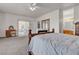 Inviting main bedroom featuring soft carpet, a sliding glass door, and a vanity area at 825 W Ryan Ave, Overton, NV 89040