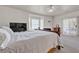 Bright main bedroom features bay window, ceiling fan, and sliding glass door to the backyard at 825 W Ryan Ave, Overton, NV 89040