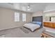 Tranquil main bedroom with plush carpet, natural light, and ensuite bathroom at 825 W Ryan Ave, Overton, NV 89040