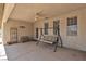 Spacious covered patio featuring a ceiling fan, swing, and neutral color scheme perfect for outdoor relaxation at 825 W Ryan Ave, Overton, NV 89040